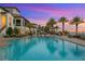 Resort-style pool area with tropical landscaping and comfortable lounge chairs at 5823 Bowen Daniel Dr # 606, Tampa, FL 33616