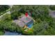 Aerial view showcasing a beautiful house with a pool surrounded by lush greenery at 5902 Audubon Manor Blvd, Lithia, FL 33547