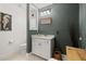 Charming half-bathroom features a white vanity, toilet, and lovely decor at 5902 Audubon Manor Blvd, Lithia, FL 33547