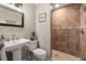 Elegant bathroom featuring a pedestal sink, toilet, and walk-in shower with decorative tile at 5902 Audubon Manor Blvd, Lithia, FL 33547