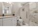 Bathroom featuring a white vanity, granite countertops, and a tiled walk-in shower at 5902 Audubon Manor Blvd, Lithia, FL 33547