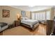 Cozy bedroom with hardwood floors, natural light from the windows, and tasteful decor creates a relaxing atmosphere at 5902 Audubon Manor Blvd, Lithia, FL 33547