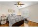 Cozy bedroom with a ceiling fan, a window with shutters, and wood floors at 5902 Audubon Manor Blvd, Lithia, FL 33547