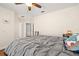 Bedroom featuring a ceiling fan, a window with shutters, and wood floors at 5902 Audubon Manor Blvd, Lithia, FL 33547