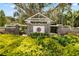 Elegant community entrance with stone columns, decorative emblem, and well-maintained landscaping at 5902 Audubon Manor Blvd, Lithia, FL 33547
