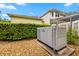 Exterior shot of a generator situated in the backyard, surrounded by rock and greenery, adjacent to the home at 5902 Audubon Manor Blvd, Lithia, FL 33547