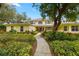 Charming two-story home with mature landscaping and a welcoming walkway to the front door at 5902 Audubon Manor Blvd, Lithia, FL 33547