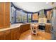 Kitchen featuring wood cabinets, wooden countertops, and view from a large window at 5902 Audubon Manor Blvd, Lithia, FL 33547