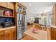 Well-appointed kitchen with stainless steel refrigerator, custom cabinets, and center butcher block at 5902 Audubon Manor Blvd, Lithia, FL 33547