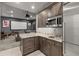 Kitchenette featuring granite countertops, cabinetry, and stainless steel appliances, adjacent to theater at 5902 Audubon Manor Blvd, Lithia, FL 33547