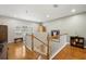 Bright landing featuring hardwood floors, white banisters, and an arched window at 5902 Audubon Manor Blvd, Lithia, FL 33547