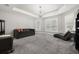 Bright living room featuring a decorative chandelier, modern furniture, and a tray ceiling at 5902 Audubon Manor Blvd, Lithia, FL 33547