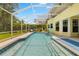 Inviting screened-in pool with easy access steps, surrounded by lush landscaping at 5902 Audubon Manor Blvd, Lithia, FL 33547