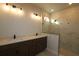 Modern bathroom featuring double vanity sinks, marble-like tiling, and a glass-enclosed shower at 6270 Broad Field Ave, Apollo Beach, FL 33572