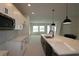 Modern kitchen with white and brown cabinets, center island, pendant lights, and stainless steel appliances at 6270 Broad Field Ave, Apollo Beach, FL 33572