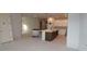 Open kitchen with a center island featuring dark cabinets and pendant lights, flowing into a spacious room at 6270 Broad Field Ave, Apollo Beach, FL 33572