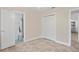 Neutral bedroom with access to a bathroom, closet, and open doorway at 628 Bosphorous Ave, Tampa, FL 33606