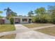 Quaint home with a convenient carport, mature trees, and a pristine front yard at 628 Bosphorous Ave, Tampa, FL 33606