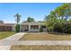 Inviting home with a spacious carport, mature palm trees, and a well-maintained lawn at 628 Bosphorous Ave, Tampa, FL 33606