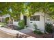 Charming white brick home featuring dark trim windows, a welcoming front porch, and verdant landscaping at 628 Bosphorous Ave, Tampa, FL 33606