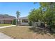 Attractive single-story home featuring a well-manicured lawn, mature trees, and a cozy front porch at 628 Bosphorous Ave, Tampa, FL 33606