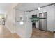 A modern kitchen with stainless steel appliances, white cabinets, and breakfast bar at 628 Bosphorous Ave, Tampa, FL 33606