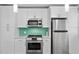 Modern kitchen showcasing stainless steel appliances, white cabinets, and a stylish backsplash at 628 Bosphorous Ave, Tampa, FL 33606