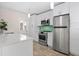 Bright kitchen with stainless steel appliances, white cabinetry, and a tile backsplash at 628 Bosphorous Ave, Tampa, FL 33606