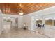 Open-concept living room featuring tile floors, wood ceiling and view of other rooms at 628 Bosphorous Ave, Tampa, FL 33606