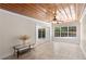 Spacious living room featuring a wood ceiling, tile floors and view of the pool at 628 Bosphorous Ave, Tampa, FL 33606