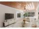 Cozy living room with wood ceiling, large windows, and access to the outdoors at 628 Bosphorous Ave, Tampa, FL 33606