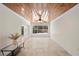 Spacious living room featuring a wood ceiling, tile floors and view of the pool at 628 Bosphorous Ave, Tampa, FL 33606