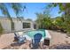 Relaxing pool area with lush greenery and blue chairs under a clear sky at 628 Bosphorous Ave, Tampa, FL 33606