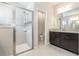 Bathroom with a walk-in shower, granite countertop, and dark wood cabinets at 6524 Park Strand Dr, Apollo Beach, FL 33572