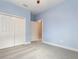 Bedroom featuring neutral carpet, light blue walls, a ceiling fan, a closet, and a doorway at 6524 Park Strand Dr, Apollo Beach, FL 33572
