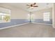 Spacious carpeted bedroom featuring a ceiling fan and abundant natural light at 6524 Park Strand Dr, Apollo Beach, FL 33572