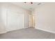 Bedroom featuring neutral carpet, a ceiling fan, a closet, and a doorway at 6524 Park Strand Dr, Apollo Beach, FL 33572