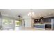 Bright and airy living area flows into the kitchen, featuring sliding glass doors at 6524 Park Strand Dr, Apollo Beach, FL 33572
