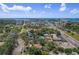 Aerial view of home in a quiet neighborhood close to the water and city, showcasing lush landscapes at 6821 Date Palm S Ave, St Petersburg, FL 33707