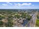 Aerial shot of home in a quiet neighborhood near the city, showing mature trees and surrounding landscape at 6821 Date Palm S Ave, St Petersburg, FL 33707