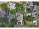 Overhead aerial shot of home with a beautiful pool and driveway in quiet green neighborhood at 6821 Date Palm S Ave, St Petersburg, FL 33707