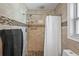 Updated bathroom with tiled shower, mosaic accents, and modern fixtures at 6821 Date Palm S Ave, St Petersburg, FL 33707