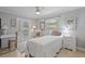 This bedroom includes tile floors, a ceiling fan, and french doors leading to the backyard at 6821 Date Palm S Ave, St Petersburg, FL 33707