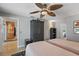 Comfortable bedroom with two twin beds, dark furniture, and tile flooring at 6821 Date Palm S Ave, St Petersburg, FL 33707