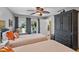 Well-lit bedroom with a ceiling fan and view of the outdoor pool area at 6821 Date Palm S Ave, St Petersburg, FL 33707
