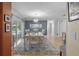 Elegant dining room with stylish chandelier and sliding doors to the outdoor pool area at 6821 Date Palm S Ave, St Petersburg, FL 33707