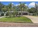Beautiful single-story home featuring mature landscaping and palm trees along the front walkway at 6821 Date Palm S Ave, St Petersburg, FL 33707