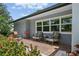 Cozy outdoor patio featuring comfortable seating, brick pavers, and views of the surrounding greenery at 6821 Date Palm S Ave, St Petersburg, FL 33707