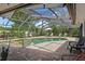 A covered swimming pool and hot tub with brick flooring and surrounding landscaping at 6821 Date Palm S Ave, St Petersburg, FL 33707