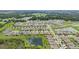 A high-angle shot displaying a community with ponds, lush greenery and various houses at 7323 Steer Blade Dr, Zephyrhills, FL 33541